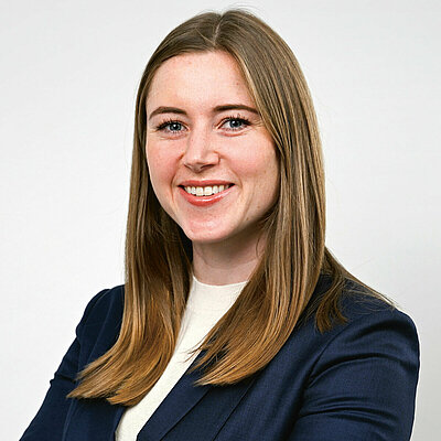 Portrait of Seonag Doherty, Vice President of Corporate Development, wearing a blue blazer and white shirt against a white background