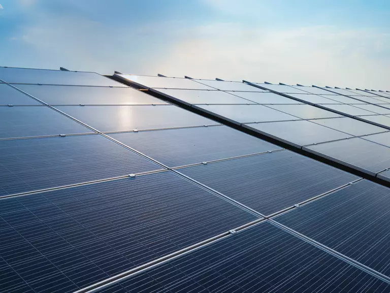 Solar panels illuminated by the sun with blue sky