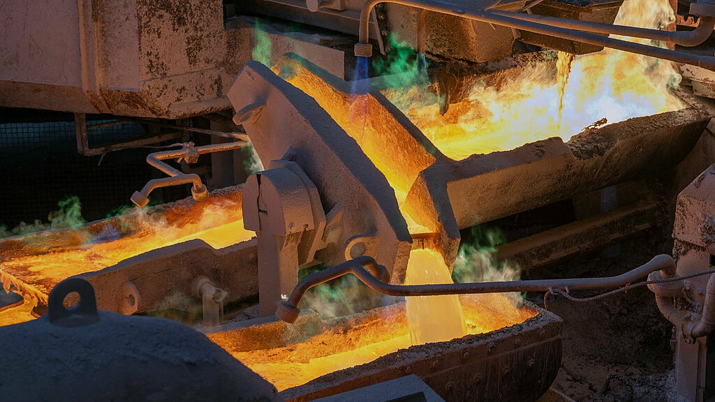 Steaming, molten metal being further processed.