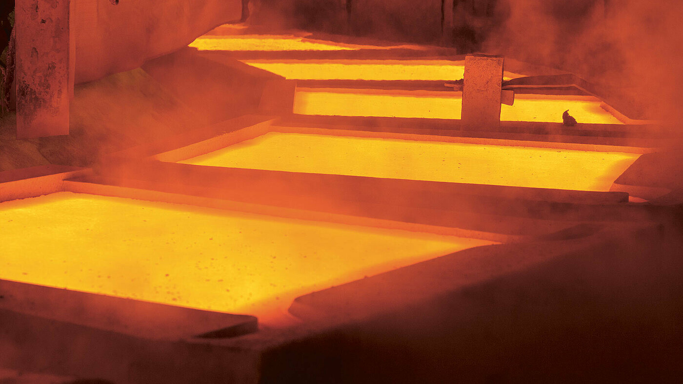 Basin with glowing liquid copper in a smelter